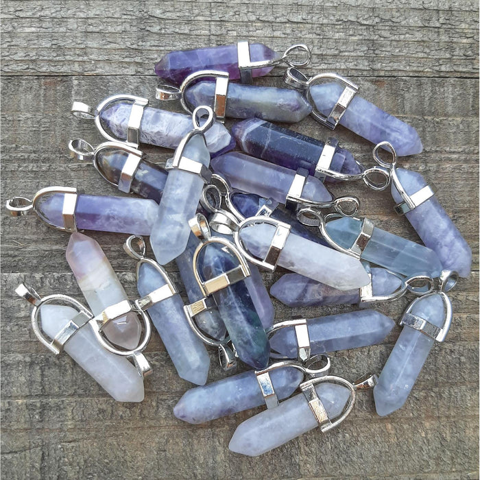 Flourite Crystal Point Pendants grouped in a pile